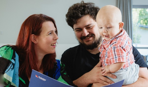 A family of tenants reviewing pukeko booklet